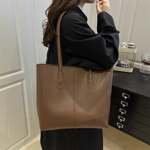 Minimalist brown large capacity tote bag with vertical stitching for commuter women