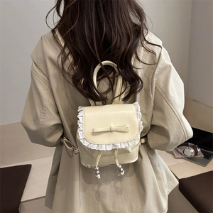 Mini ballet-style bucket backpack in cream PU leather with lace trim and bow detail