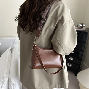 Retro deep brown wide-strap shoulder bag with geometric pattern and metallic rivets