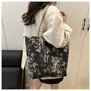 Action shot of large tote bag with bamboo leaf print and durable wide straps