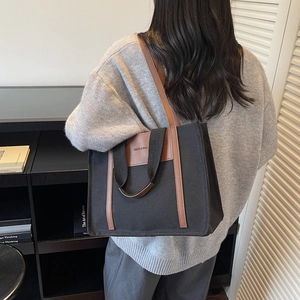 Large black canvas tote bag with brown leather straps for autumn winter daily commuting