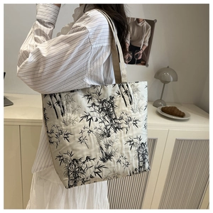 Detail of canvas tote bag with black ink bamboo print and thick khaki woven handle