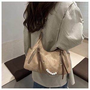 Detail of khaki retro tote bag featuring pearl chain accents and side zipper decor