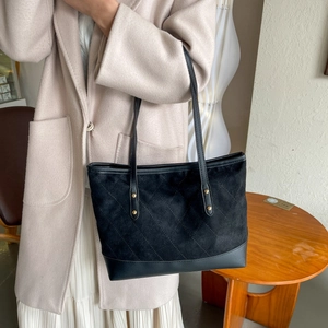 Vintage large capacity black tote bag with quilted pattern and gold studs on shoulder strap