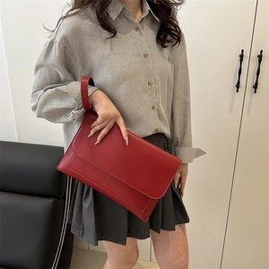 Red leather envelope clutch bag with wristlet strap for stylish commute and daily use