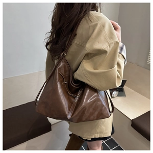 Deep brown vintage leather tote bag shown on model for a stylish commute look