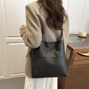Minimalist large black leather bucket bag with wide strap for women casual style