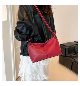 Red lychee pattern leather bucket bag detail with gold hardware and stylish knot design