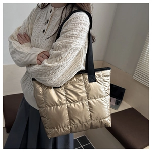Detailed view of quilted gold space cotton tote bag with stylish metallic lattice pattern