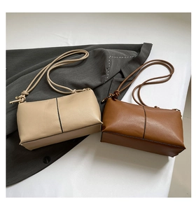 Detail of minimalist beige and brown shoulder bags with sleek lychee grain texture