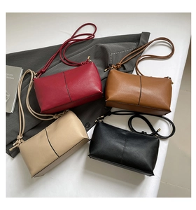 Flat lay of minimalist leather underarm bags in red, brown, beige, and black colors