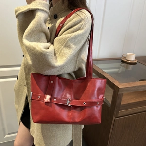 Large red tote bag with decorative metal buckle straps for women's stylish daily commute