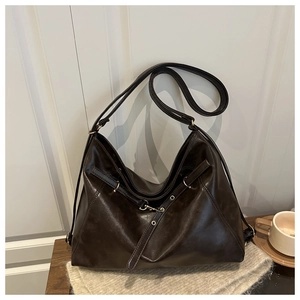 Detailed view of vintage dark brown faux leather hobo bag with adjustable shoulder strap