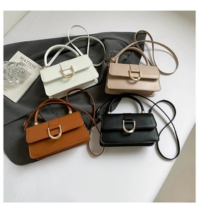 Detailed view of four elegant square handbags in white, beige, brown, and black colors