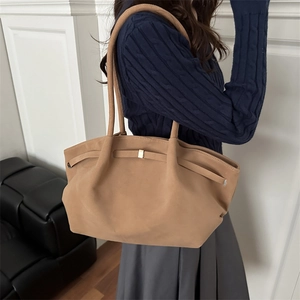 Minimalist camel suede bucket tote bag with slim straps and golden buckle detail