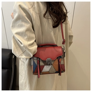 Detail of vintage patchwork crossbody bag with textured leather and multi-color patterns