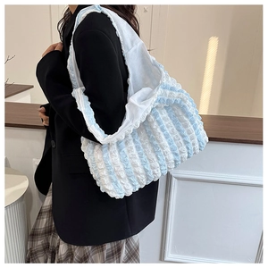 Detail showing blue and white striped popcorn bubble texture on large tote bag