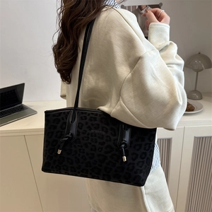 Chic black leopard print shoulder tote bag with minimalist slim straps and metal detail
