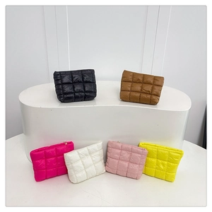 Detailed view of quilted nylon handbags in six vibrant colors with metal zipper detail