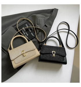 Detail of glitter flap handbags with gold shield locks in beige and black variants