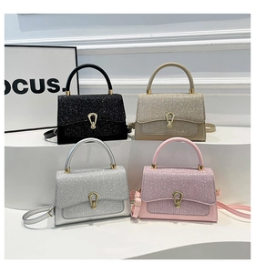 Detailed view of sparkly glitter handbags in black, gold, silver and pink with metal locks