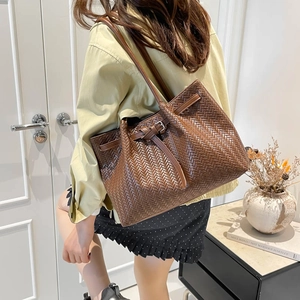 Dark brown woven tote bag with a chic shoulder strap for modern minimalist women
