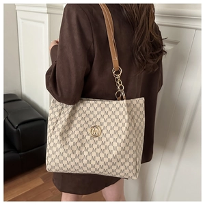 Détail du grand sac cabas avec motif jacquard M et bandoulière chaîne dorée
