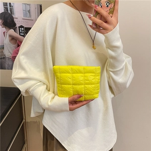 Bright yellow quilted pleated clutch bag in waterproof nylon fabric for women