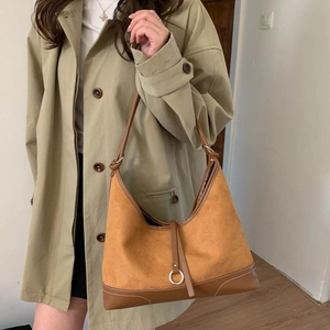 Retro color-block suede tote bag with brown leather trim worn by a model in a trench coat