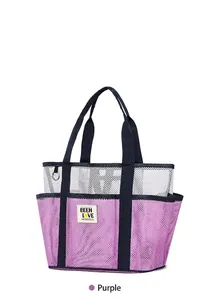 Detail of purple mesh beach bag showing multiple pockets and durable blue handles