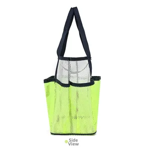 Side view showing multi-pocket mesh beach bag with reinforced handles and green mesh