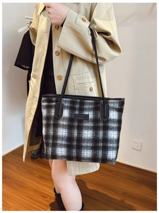 Detail of the large black and white plaid tote bag with FASHION & BAGS leather label
