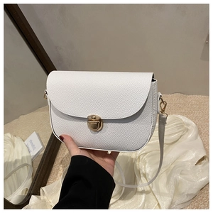 Close-up of white litchi grain saddle bag with a premium golden flip lock buckle