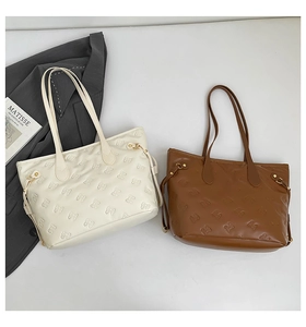 Detailed view of cream and brown tote bags featuring embossed bow-knot texture patterns