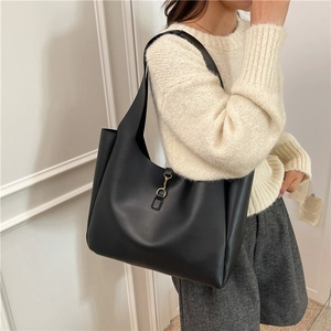 Minimalist black matte faux leather large tote bag with gold metal hook closure