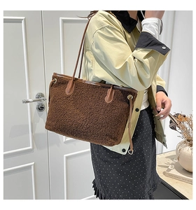 Brown fleece tote bag with faux leather trim styled on a model in a vintage setting