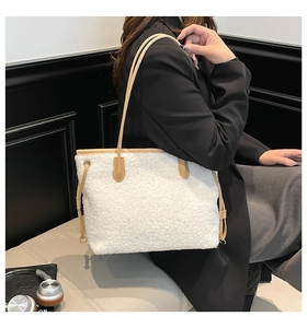 Detail of plush white tote bag with contrast brown leather straps and drawstring accents