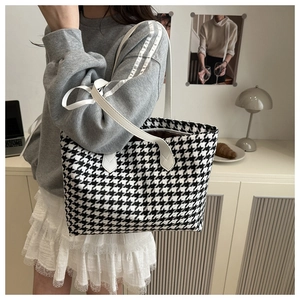 Classic houndstooth tote bag shown on model highlighting commuter style and large capacity