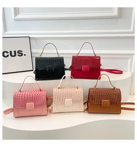 Five assorted colors of crossbody bags featuring crocodile pattern texture and top handles
