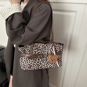 Retro leopard print tote bag with brown leather straps and plush bear charm decoration