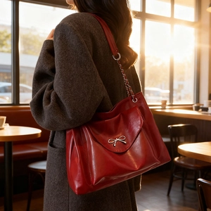 Minimalist large capacity tote bag in dark red leather with chic silver bow detail