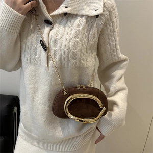 Brown suede mini round crossbody bag with gold circular handle and metal chain strap