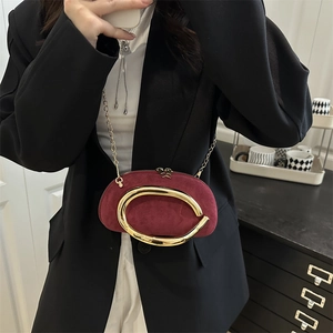 Burgundy suede circular evening bag with gold ring handle and metal chain strap