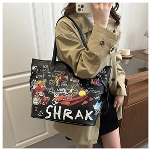 Detail of black tote bag with colorful bear graffiti and street art embroidery