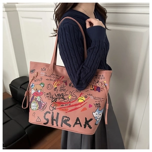 Detail view of pink tote bag with street art graffiti and side drawstring adjustment