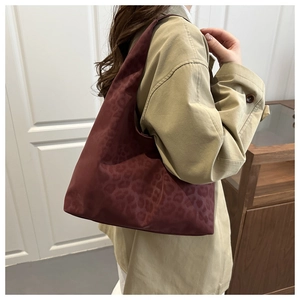 Detail view of burgundy leopard print hobo bag with durable matte fabric texture