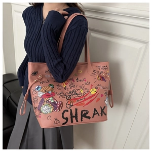 Pink tote bag detail with cartoon bear graffiti and decorative side drawstrings