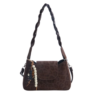 Deep brown leopard print crescent bag with woven shoulder strap and beaded charm details