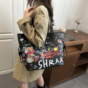 Black tote bag with cartoon bear graffiti and street art lettering shown on model
