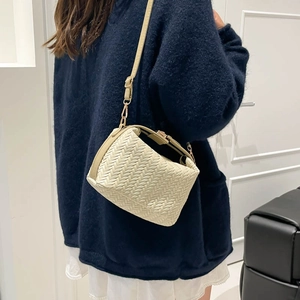 Chic cream-white woven crossbody bag with elegant V-pattern texture and gold metal hardware